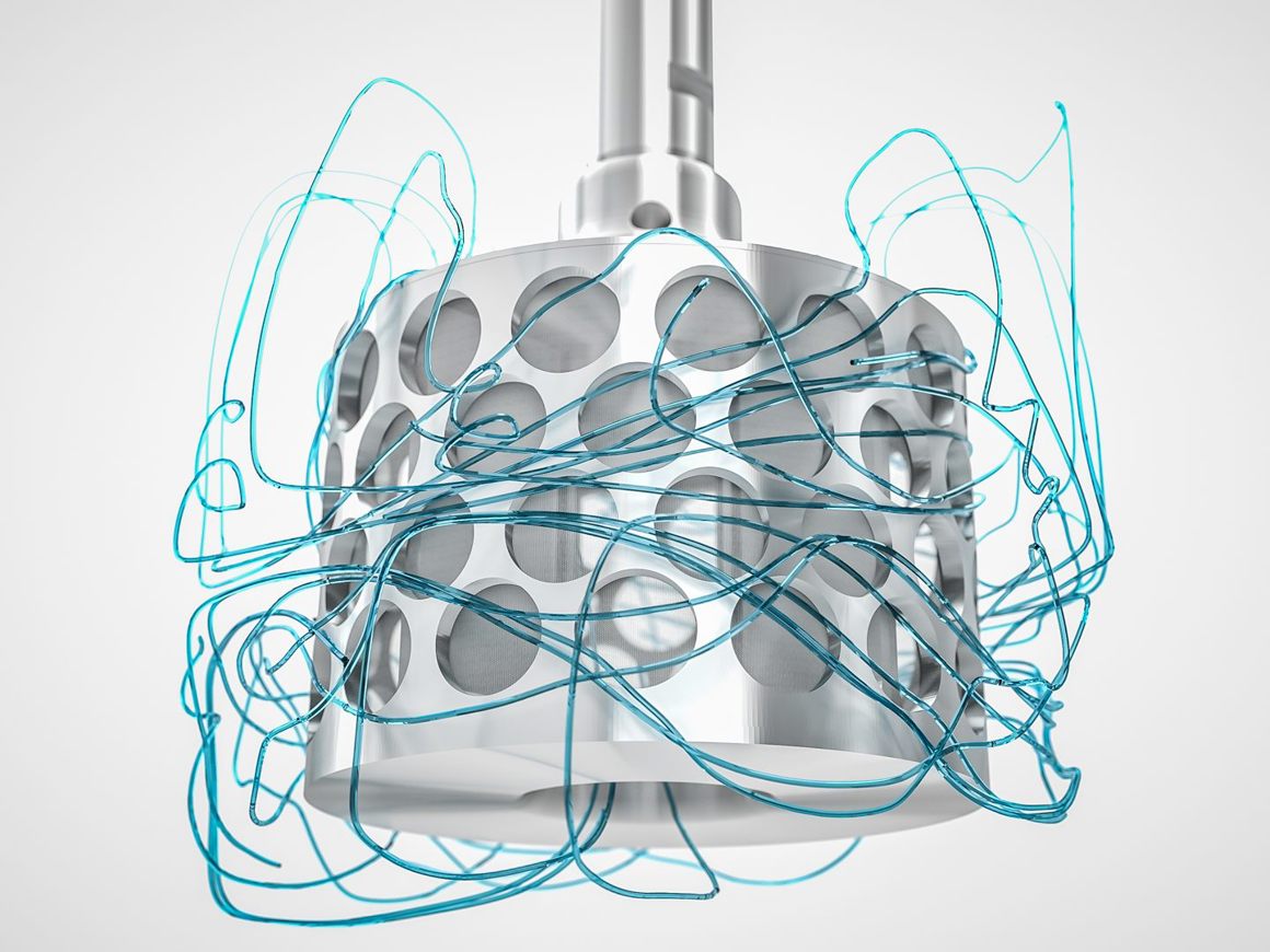 SpinChem rotating bed reactor with perforated metallic cylinder surrounded by flowing turquoise liquid visualization trails showing fluid dynamics and mass transfer patterns.