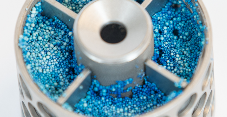 Ion-exchange resin in the rotating bed reactor. The resin has a blue colour due to the adsorbed phenol.